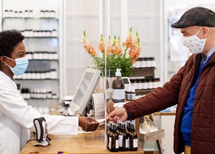 man interacting with pharmacist